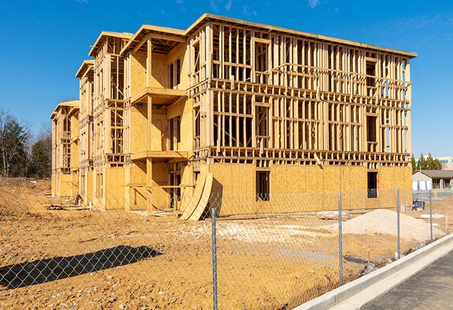 a temporary chain link fence in front of a building under construction, ensuring public safety in Sylvan Beach